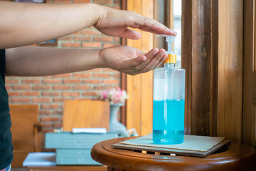 Women hand washing with ethyl alcohol gel or antibacterial soap sanitizer after visit restaurant Hygiene concept.