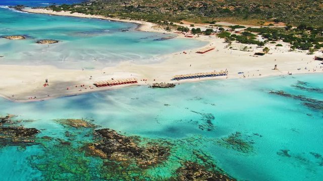 Static aerial shot of turquoise color water on the beachs surrounding Elafonisi island, Crete