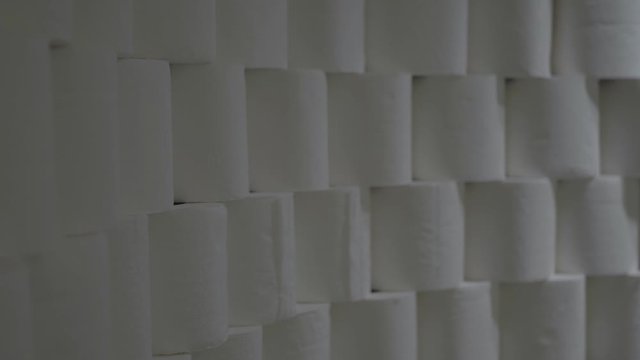 Toilet Paper Rolls Stacked In Rows. Light Moves To The Right And Back To The Left