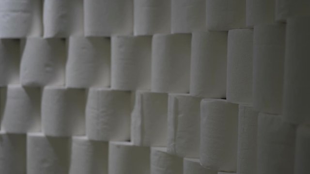 Toilet Paper Rolls Stacked In Rows. Light Moves To The Left And Back To The Right