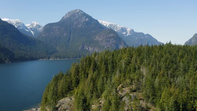Drone flying over mountain towards beautiful lake view