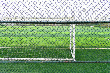 a soccer field behind the fence