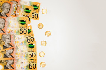 Australian dollars 50 banknotes and coins with copy space. Finance concept