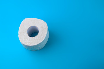 Toilet paper on a blue background. Shortage in COVID-19 stores. Concept