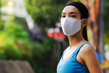 young woman in a mask for particulate matters and coronavirus protection
