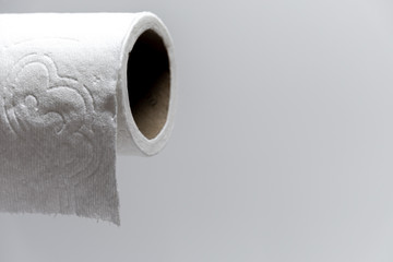 Toilet Paper Running Low with white background as panic buying triggers a supply shortage during the Coronavirus COVID-19 shelter in place quarantine lockdown