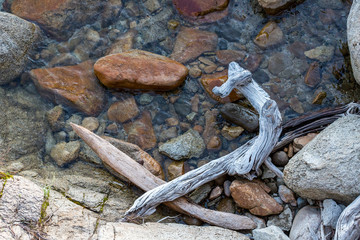 Driftwood and rocks at the waters edge  Lake Tahoe Sand Harbor recreational area