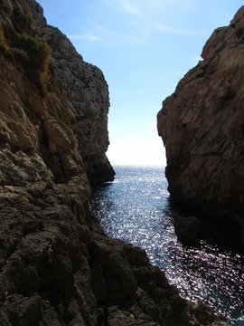 Flowing through an ocean gorge at Wied Babu Zurrieq in Malta