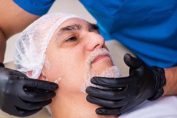 Old man visiting male doctor for plastic surgery