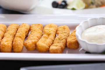 Chicken nuggets with sweet sauce on white plate table closeup background
