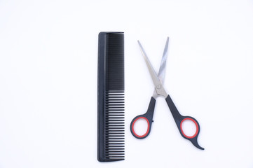 Black comb and scissors isolated on white background