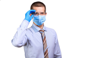 Male doctor wearing medical mask, rubber gloves, correcting glasses with hand