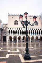 Obraz premium Old Street Lantern in Venice on San Marco Square. Early Rainy Morning. Cloudy Sky.