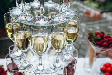 Champagne glasses. Wedding slide champagne for bride and groom. Colorful wedding glasses with champagne. Catering service. Catering bar for celebration. Beauty of bridal interior for wedding.