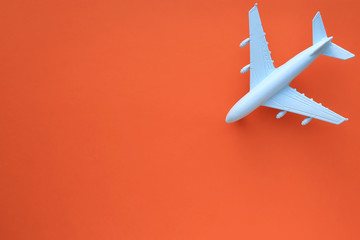 Model airplane on a orange background. Space for text. Travel concept.