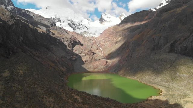 Shallap, the green lake in the peruvian andes, river and lake product of the defrosting glaciers, truck shot, aerial shot