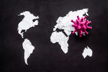 Corona virus Covid-19 - epidemic concept with world map - on black background top-down