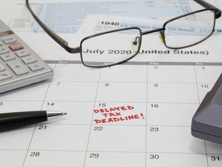 A 2020 calendar noting the USA Internal Revenue Service IRS income tax filing deadline has been moved to July 15 rather than April 15, due to the COVID-19 coronavirus pandemic, is shown up close.