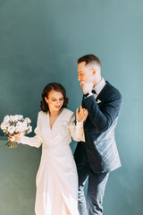 The bride and groom's romantic photo shoot. The newlyweds are happy together. Stylish modern couple in an interior Studio.