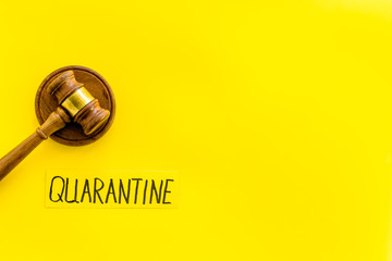 Quarantine fine. Judge gavel on yellow background top view copy space