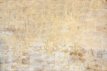 Old stucco wall texture of yellow and beige color