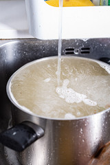 stainless cooking pot on a domestic kitchen sink ready to be washed