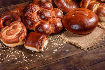 Composition of fresh baked sweet buns with poppy and jam