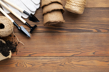 Gardening equipment at wooden background with copy space.