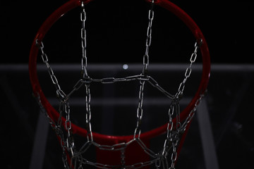 basketball ring on a street court at night