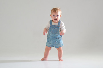 10 month old little baby learning to walk..Studio photography