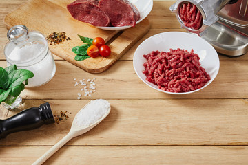Chopped raw meat and ground beef . The process of preparing forcemeat by meat grinder. Top view.