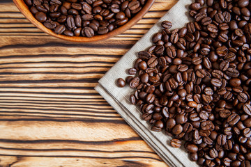 Coffee beans and fabric towel on the wooden table