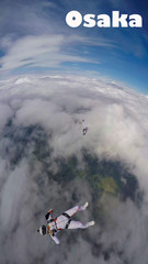 Fototapeta na wymiar Osaka. Skydiver from Osaka performs a trick in the sky. Free fall.
