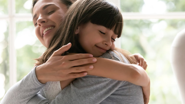Cute little girl child embrace happy young mother show gratitude and love, caring happy smiling mom hug small preschooler daughter make peace reconcile after fight, family bonding, unity concept
