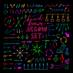 Hand drawn colorful arrows set on black background