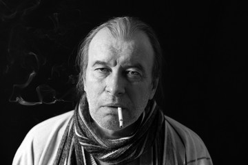 Fototapeta premium Portrait of an elderly smoking man