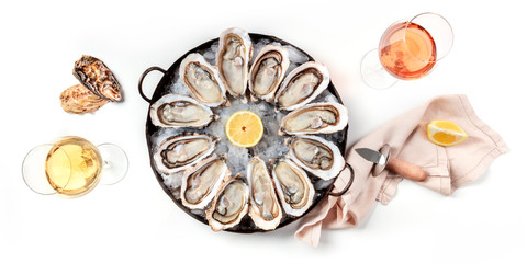 Oysters with wine, shot from the top on a white background, a panoramic flat lay