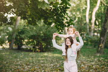 Children in a summer park. Sisters playing. Kids in a pink clothes.