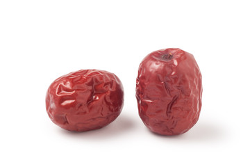 Two dried red dates isolated on white background