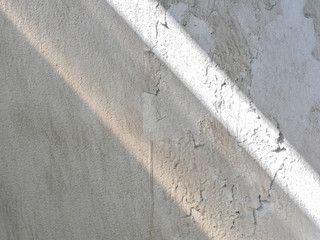 Sunrise drop shadow on old white concrete wall. 
