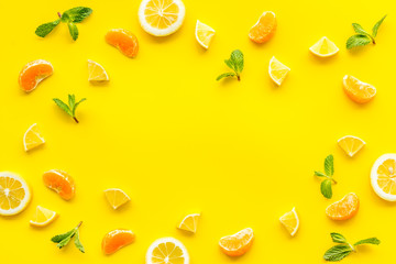 Slices fruites frame. Fruit salad concept with citruses, aplle and kiwi on yellow background top-down copy space