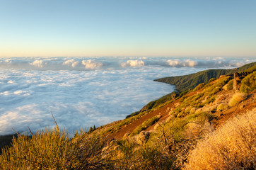 Landscape during sunset above the clouds