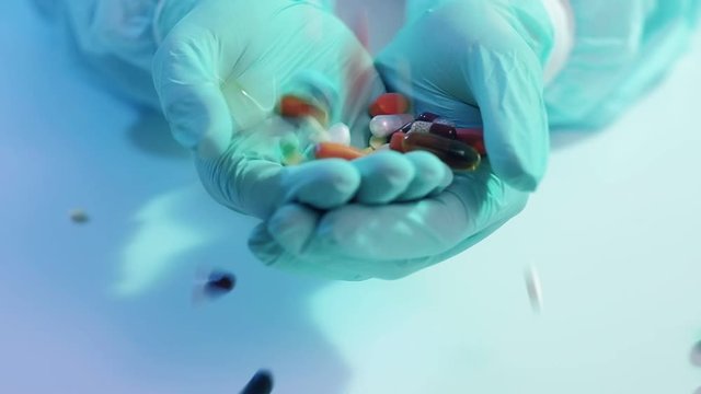 MERS infection. Drug therapy. Pills scattering into doctor hands in protective gloves.
