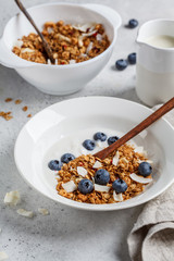 Granola with yogurt, coconut and berries in white plate. Healthy lifestyle concept.