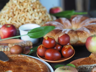 Easter background with homemade cakes and colored eggs.Festive treat on a wooden table.