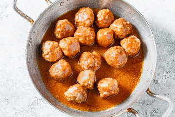 Homemade meatballs in a spicy tomato sauce. Selective focus. Close up. Top view.