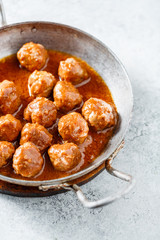 Meatballs with tomato sauce in a pan. Selective focus.