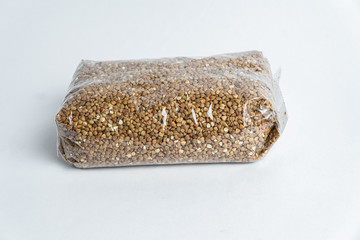 buckwheat in the plastic packet under the white background