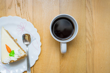 cup of coffee and cakes on wooden background