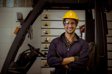 Portrait Industrial worker wearing safety uniform and safe helmet for work and control machines  with industry factory background.